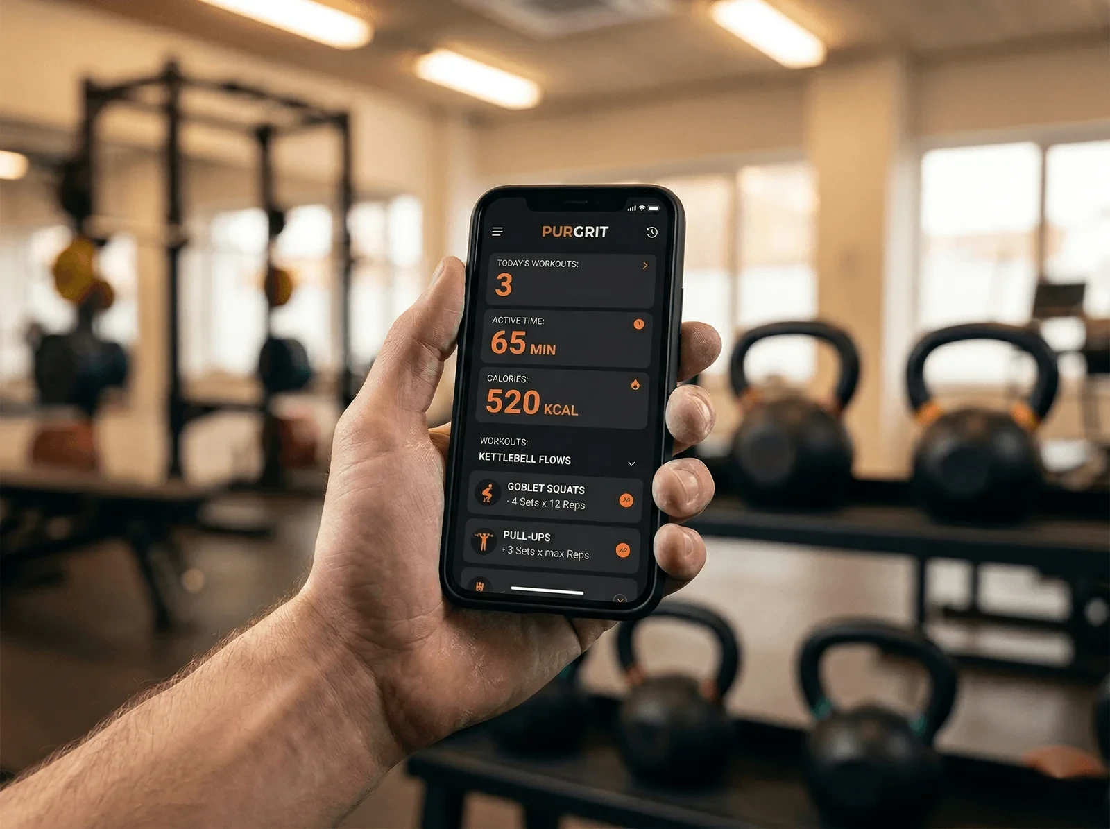 Hand holding a phone in the gym showing workout progress